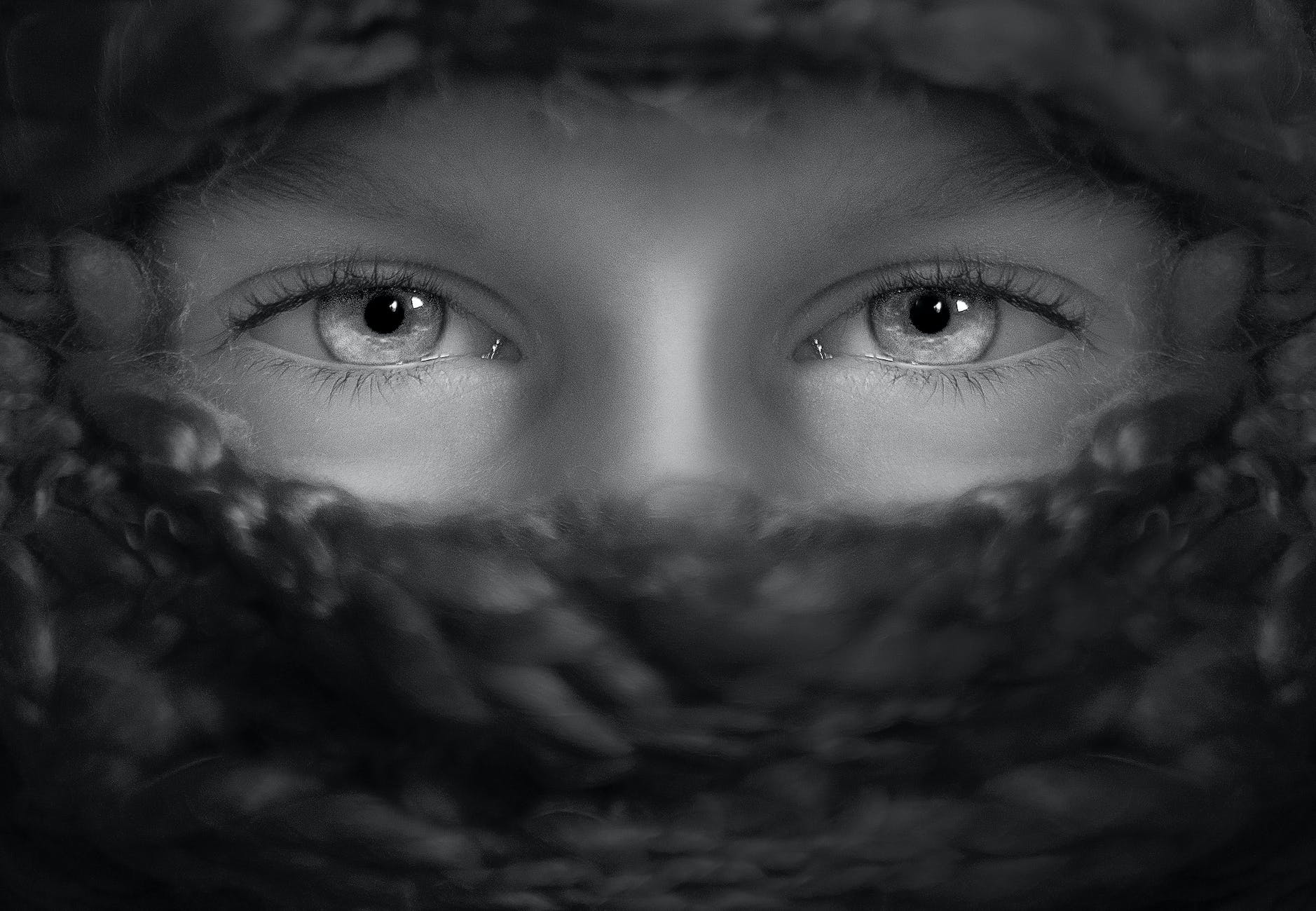 person s eye grayscale portrait photography