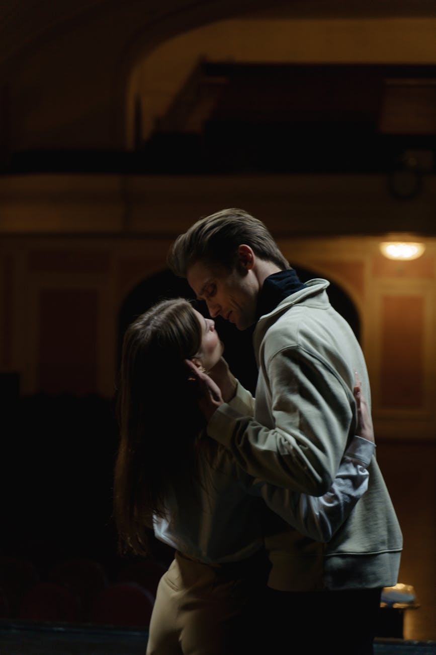 man and woman kissing inside room