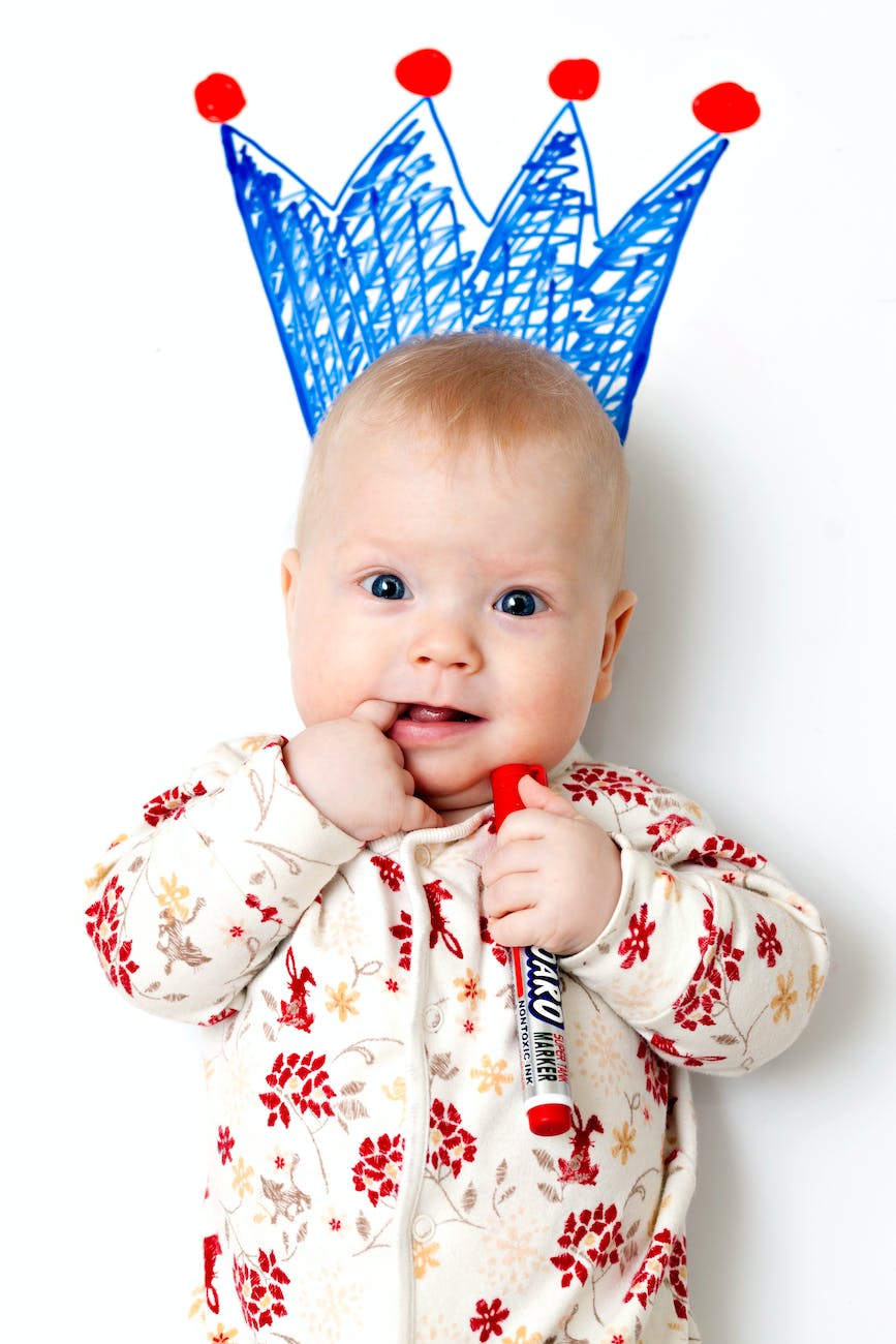 baby in white and red floral pajama