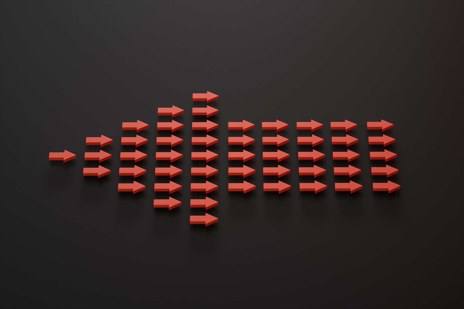 a group of red arrows on a black surface