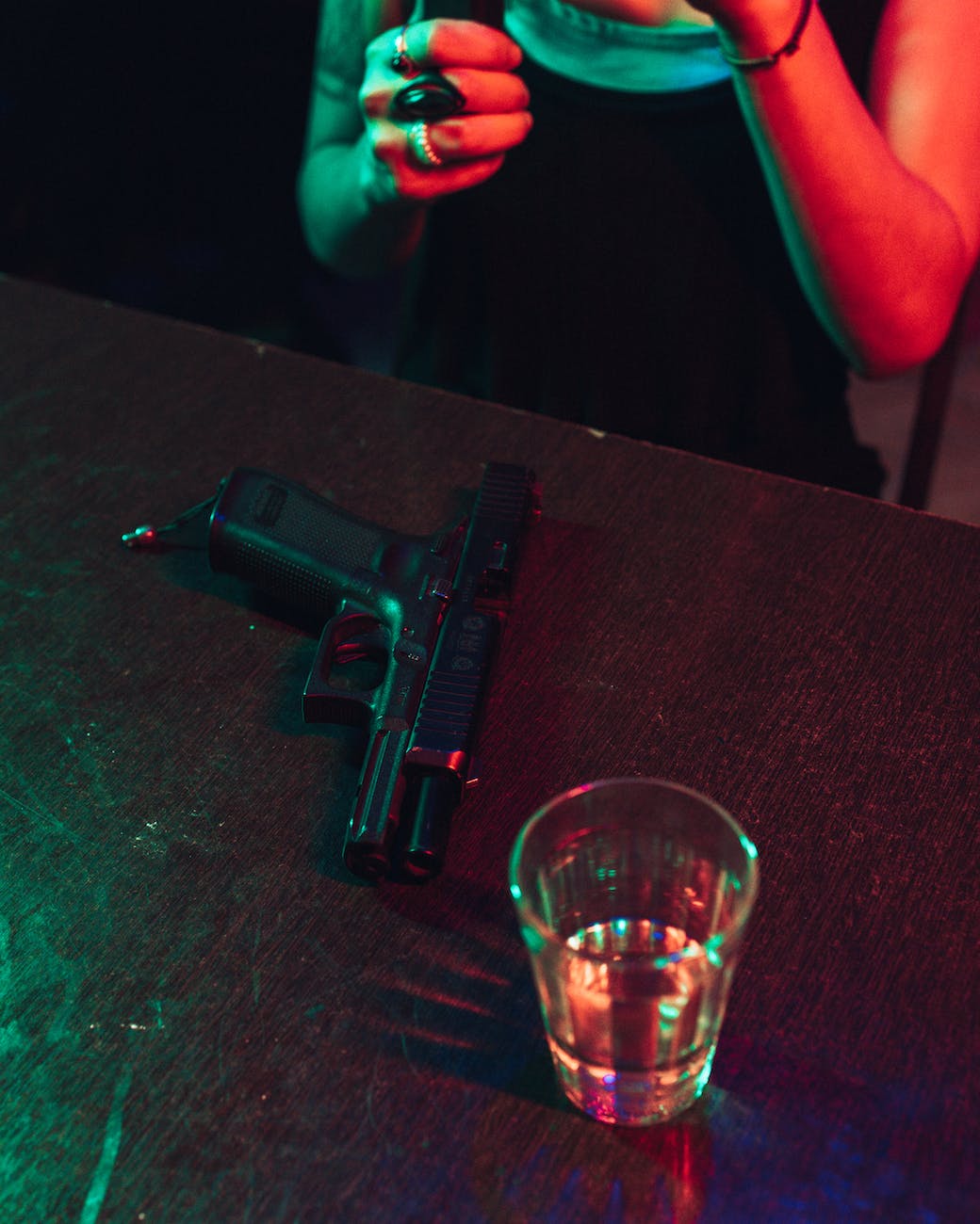 drink and gun on table