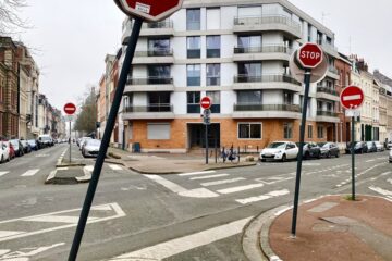 a red stop sign sitting on the side of a road